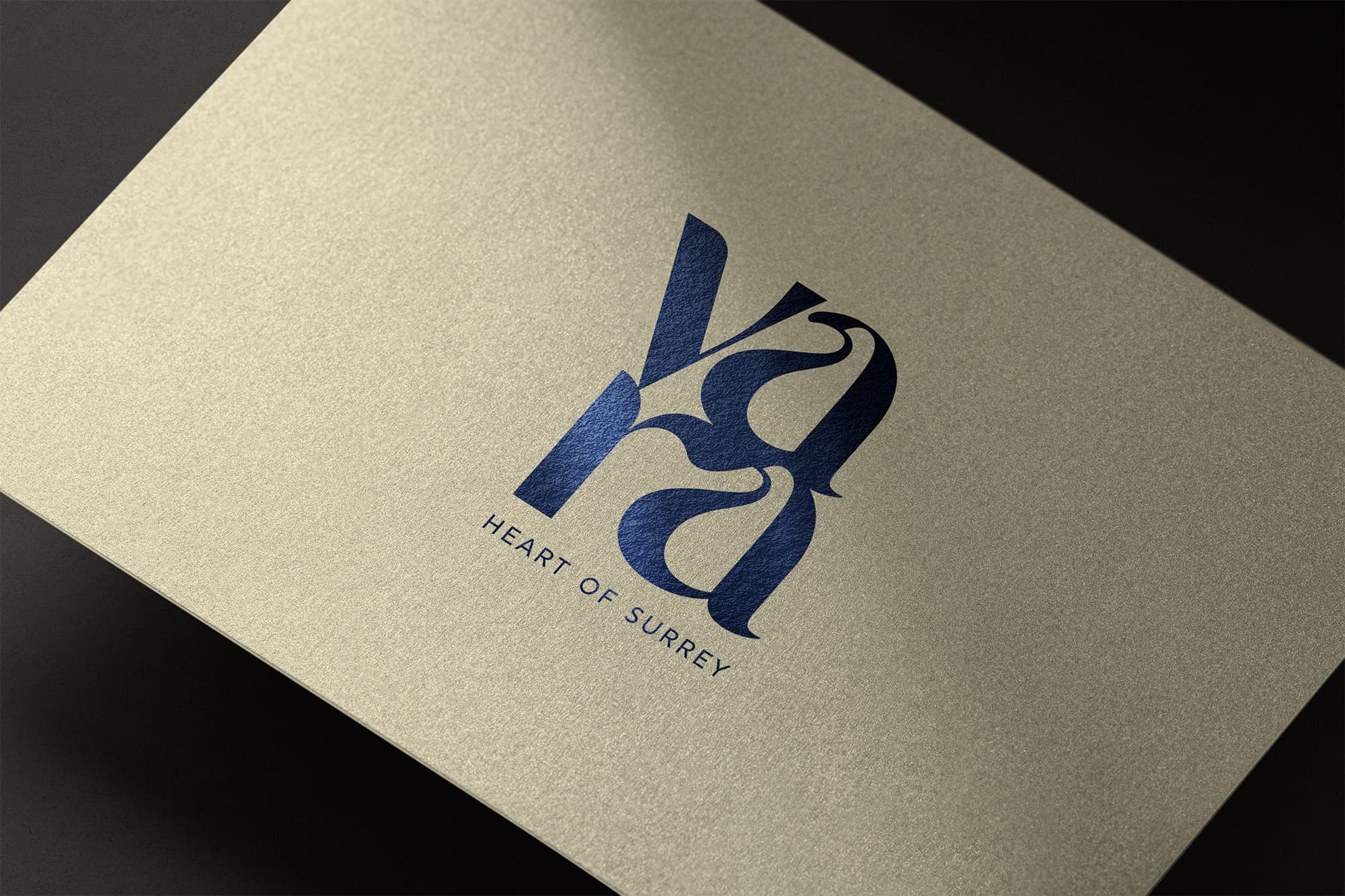 Vara wordmark and 'Heart of Surrey' tagline in navy foil on a cream textured card