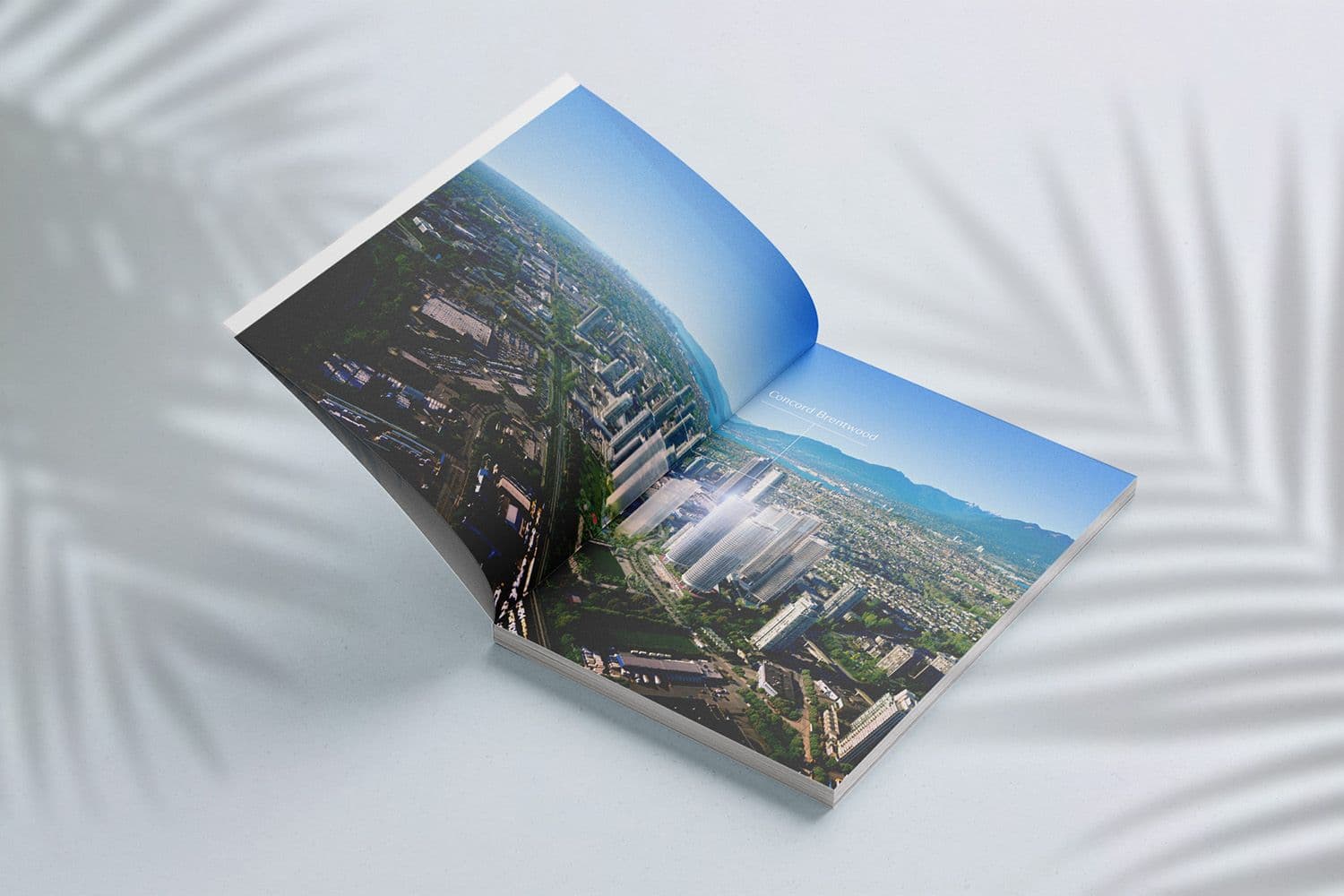 Open Concord Brentwood brochure spread with an aerial photo of the Burnaby skyline and mountains